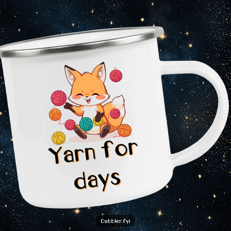 Funny camping mug with a playful fox character juggling colorful yarn balls, ideal for outdoor crafting fun.