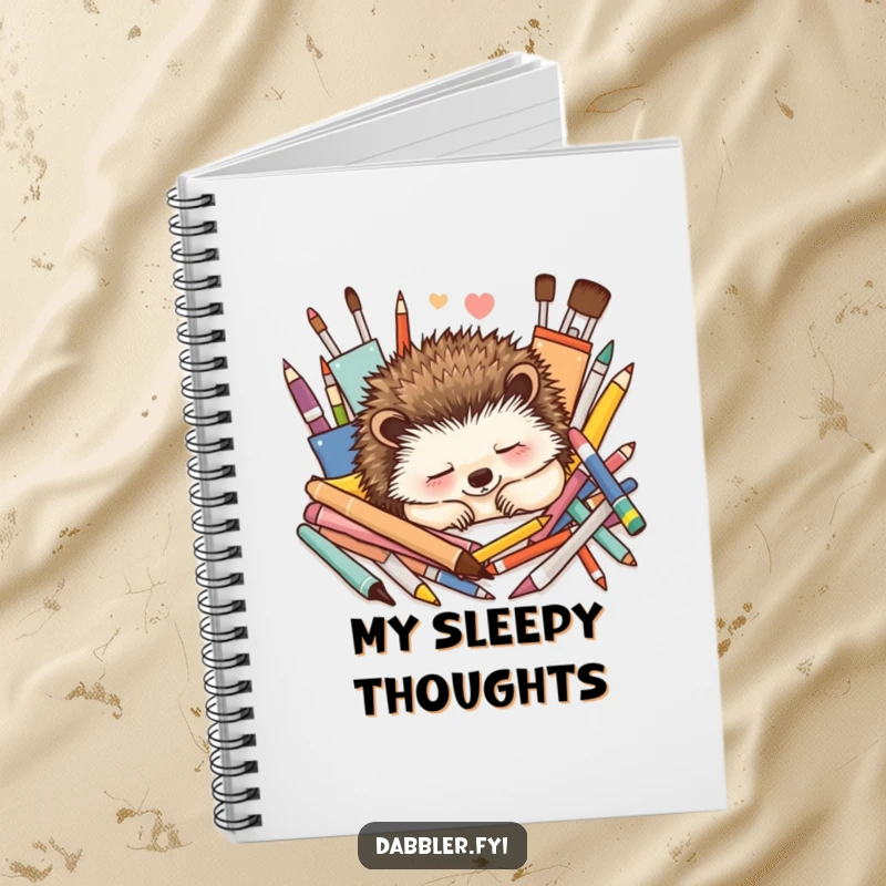 Funny Notebook: A contented hedgehog naps peacefully amidst colorful art supplies, perfect for journaling tranquil artistic thoughts.